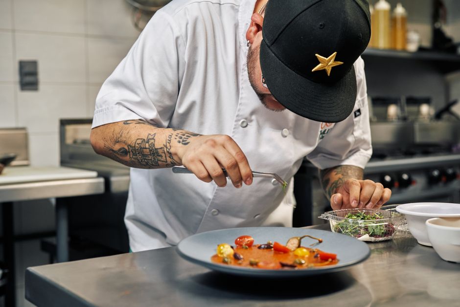 Chef carefully plating gourmet food for event catering